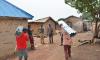 Nigerian Christians carrying roofing sheets funded by Barnabas Aid, to help them rebuild homes in safer locations after fleeing anti-Christian attacks