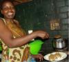 A Christian lady in Zimbabwe serving lentils