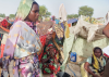 image of sudan refugees sitting down in a camp