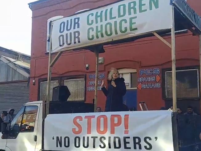 A Christian woman addresses a crowd of parents protesting outside Parkfield school in Birmingham, UK, against teaching children aged four to eleven about homosexuality and transsexualism