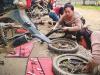 Christian young women fixing motorbikes as part of motorbike mechanic training scheme in South East Asia