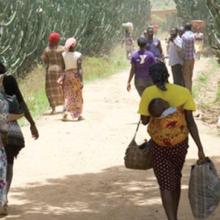 Women and children begin the long trek to safety after the devastating attack on Hura