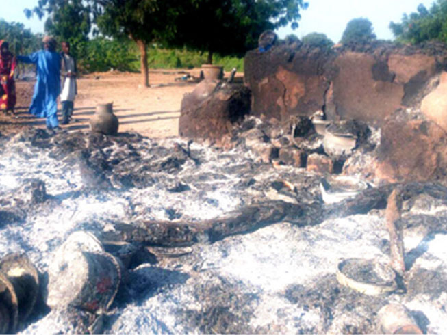 Villagers survey the ruins of their burned out homes after one of the Boko Haram attacks in Far North Cameroon