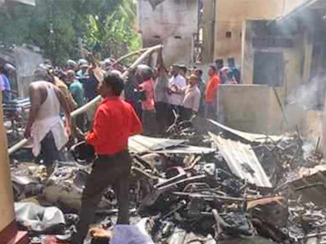 People mill about the wreckage at one of the sites that was struck by suicide bombers in Sri Lanka on Easter Day