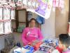 lady in a pink jumper at a shop counter